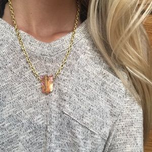 Golden chain with orange colored gems